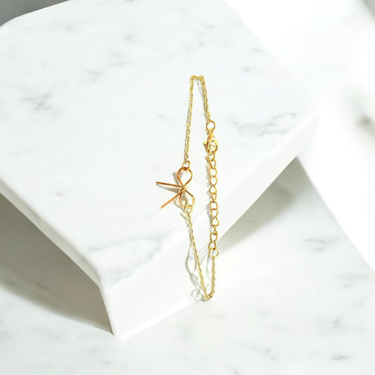 Gold-tone bow charm